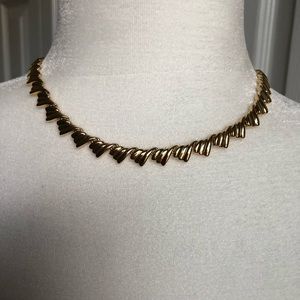 Gold color choker necklace.
